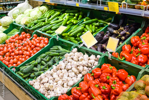 Obraz na płótnie Vegetables on the counter in the store - cabbage, cucumbers, tomatoes, garlic, eggplant, pepper w salonie