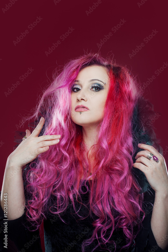 Attractive woman with pink hair in witch image. Halloween style Attractive woman with pink hair in witch image. Halloween style