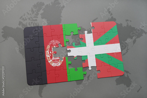 puzzle with the national flag of afghanistan and basque country on a world map background.