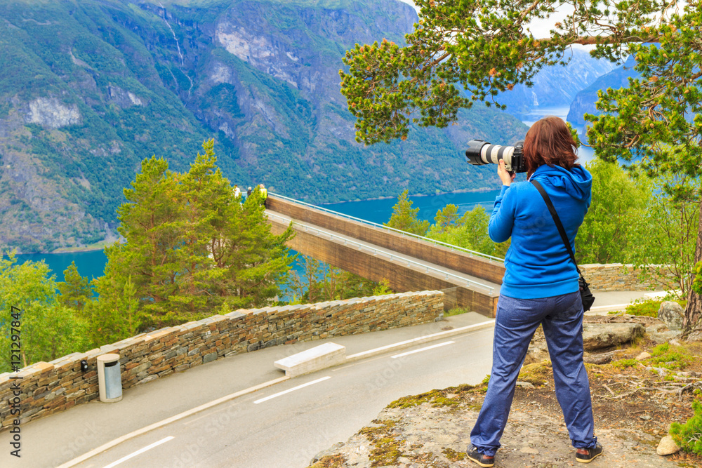 Tourist taking photo from Stegastein viewpoint Norway