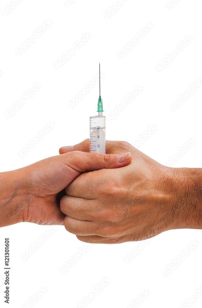 Syringe in the hands of men and women isolate on white backgroun Syringe in the hands of men and women isolate on white backgroun