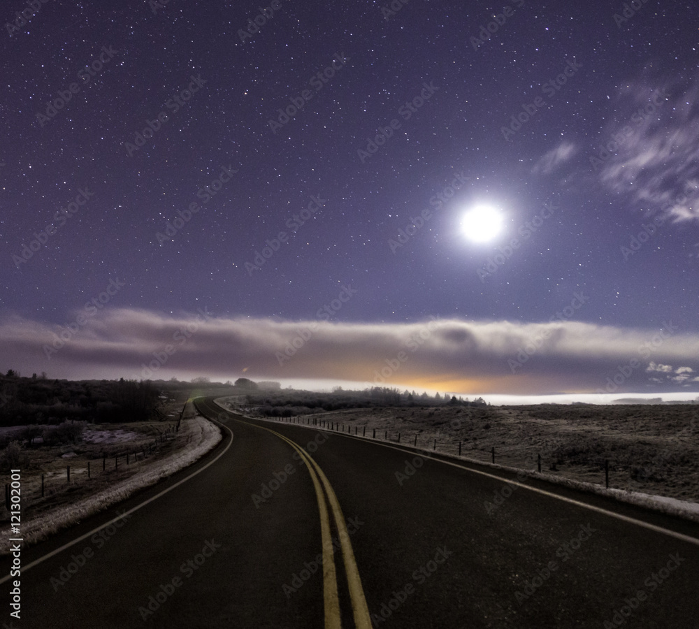 Curved road lit up by the moon