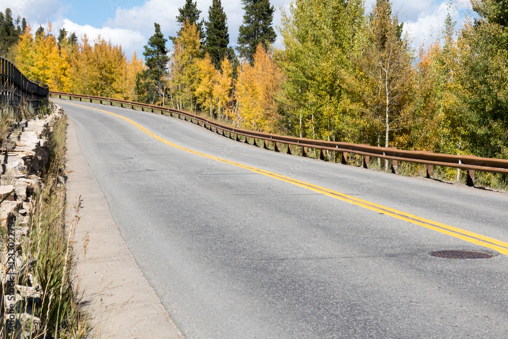 Fototapeta premium Road with guard rail and autumn color in Colorado