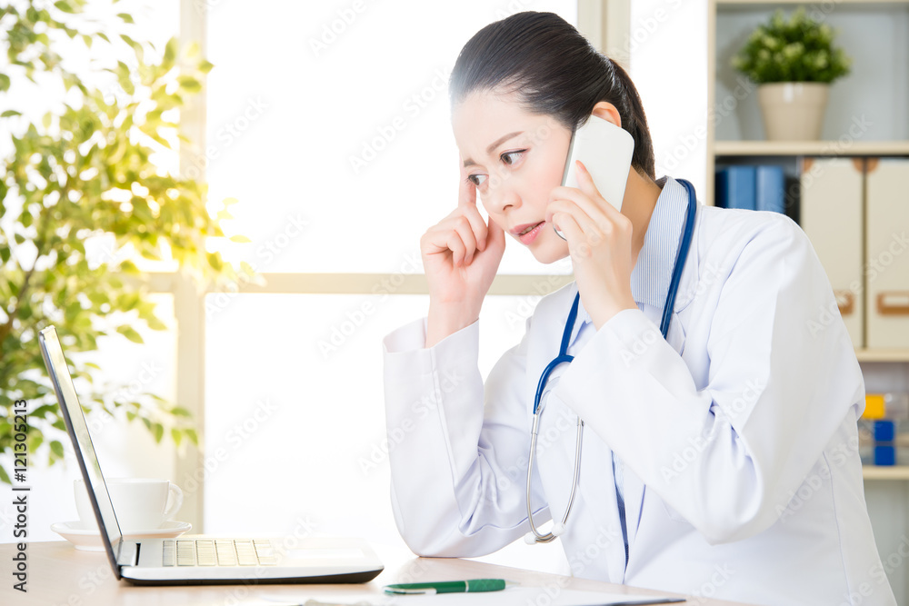Doctor explain patient's condition by smart phone and computer Doctor explain patient's condition by smart phone and computer