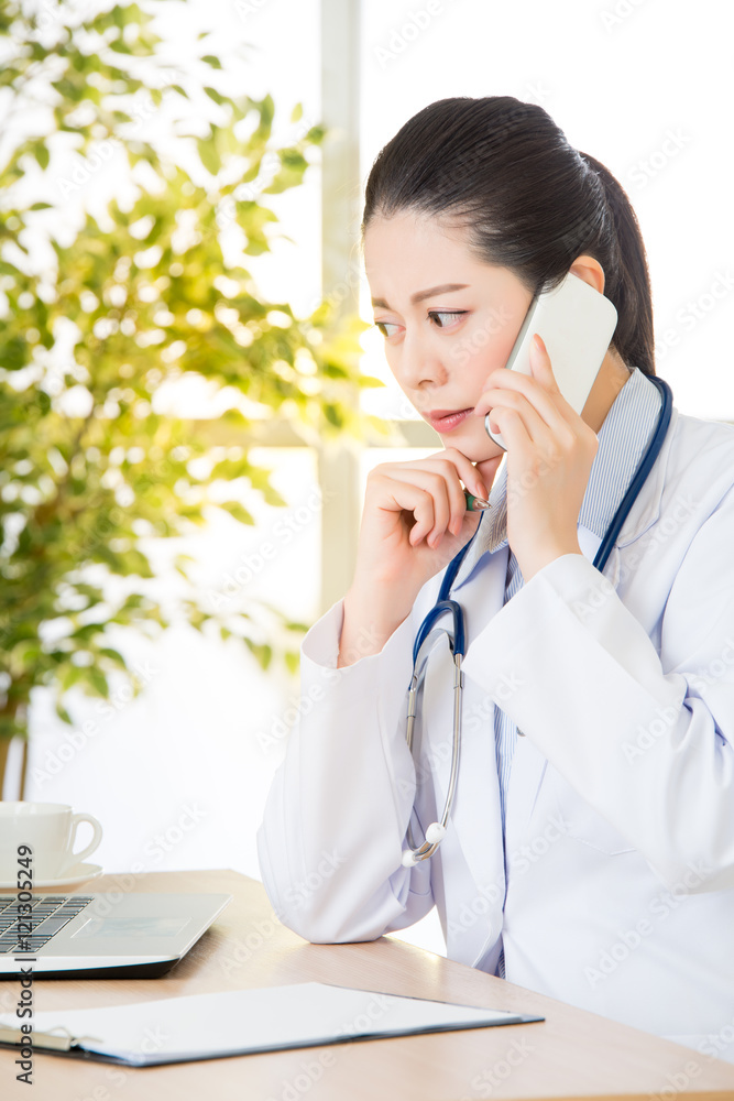 Doctor explain patient's condition by smart phone and computer Doctor explain patient's condition by smart phone and computer