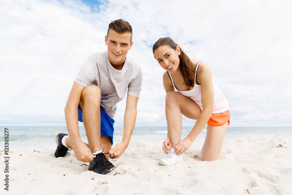 Fototapeta premium Runners lace their shoes and prepare to jogging