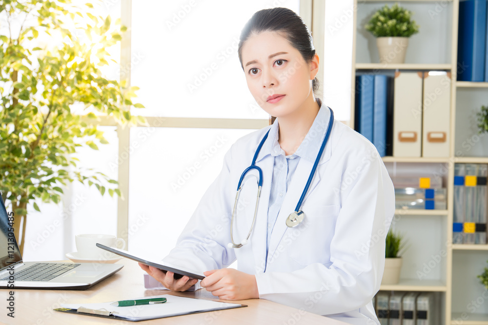 doctor using digital tablet to research patient's medical case doctor using digital tablet to research patient's medical case