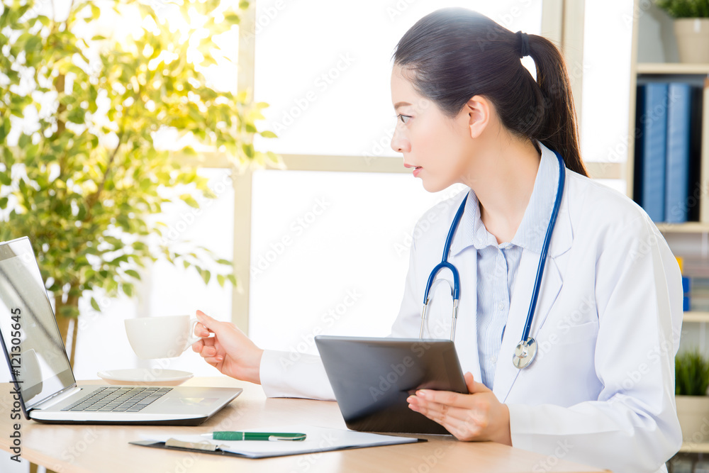 doctor drink coffee using digital tablet research patient's medi doctor drink coffee using digital tablet research patient's medi