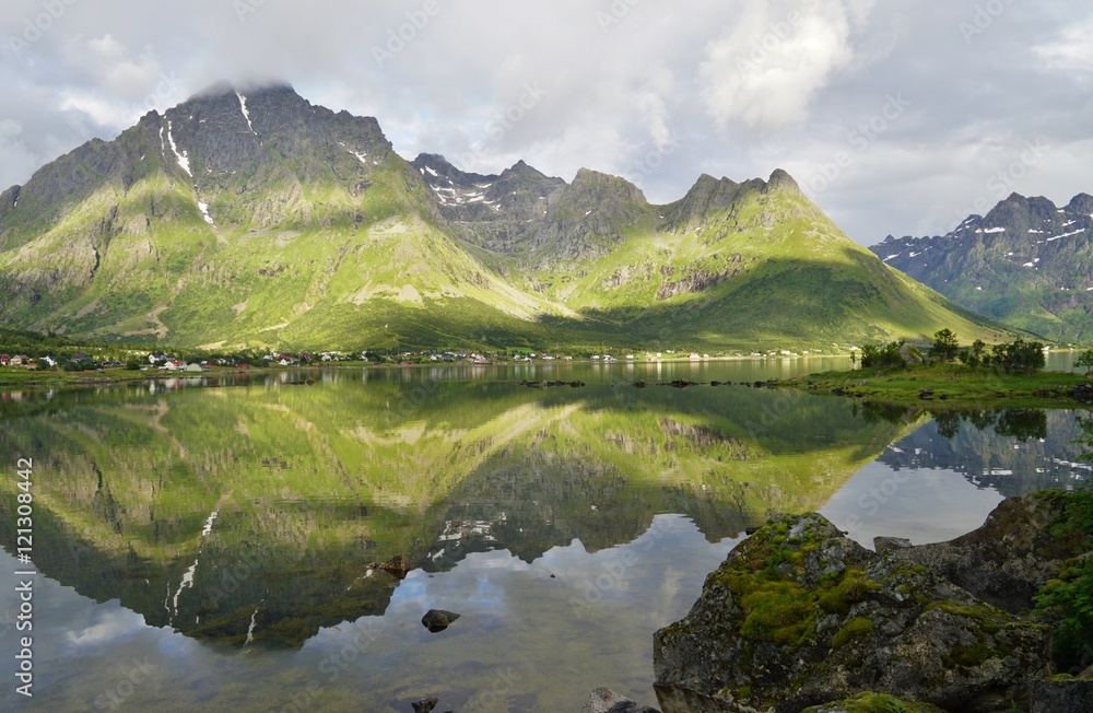 Mountains reflecting over clear water in the Lofoten Islands, Norway Mountains reflecting over clear water in the Lofoten Islands, Norway