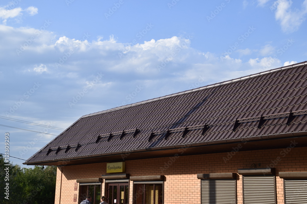 The roof of corrugated sheet on a building The roof of corrugated sheet on a building
