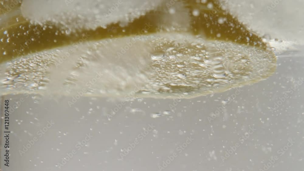 Highly carbonated water and ice cubes in the glass close-up 4K 2160p 30fps UltraHD footage - Lemon slice in cooled tonic 3840X2160 UHD video Highly carbonated water and ice cubes in the glass close-up 4K 2160p 30fps UltraHD footage - Lemon slice in cooled tonic 3840X2160 UHD video