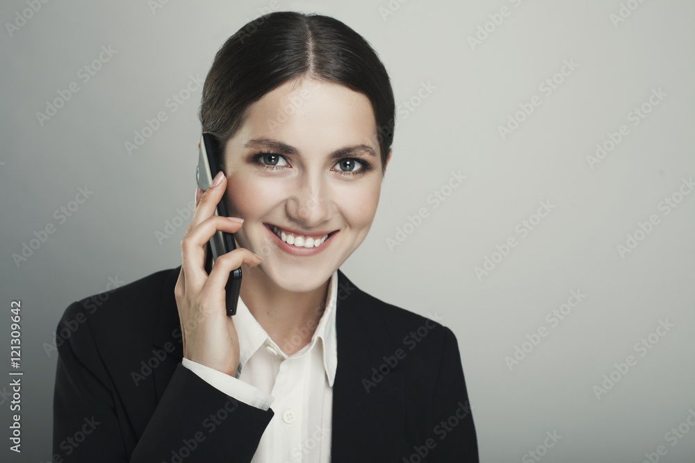 Business young woman on the phone  isolated over a grey backgrou