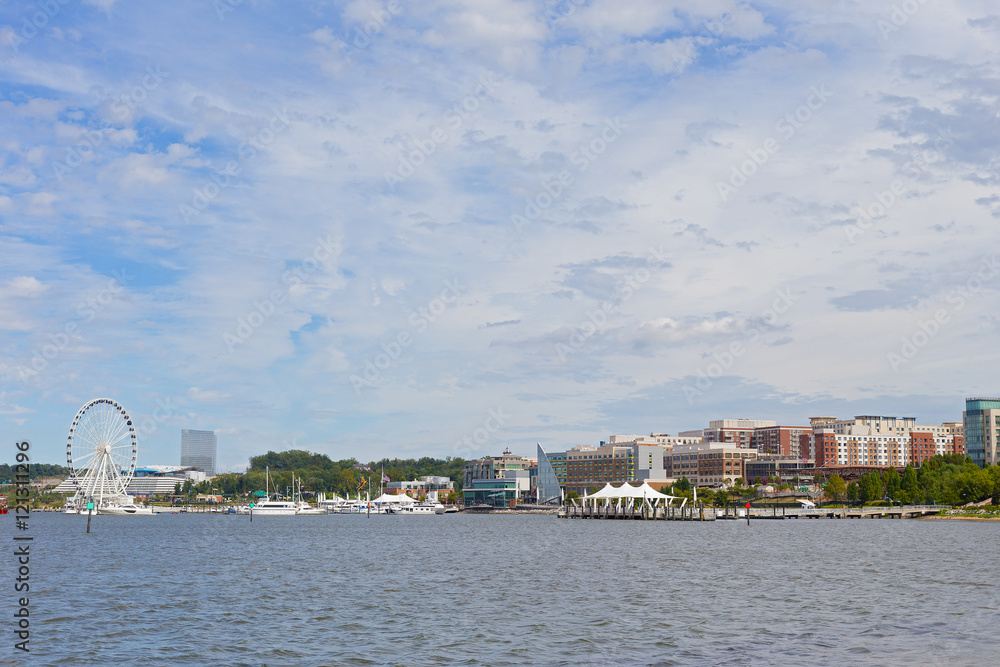Waterfront panorama of National Harbor in Maryland, USA. Boats and yachts at National Harbor pier on a bright sunny day.