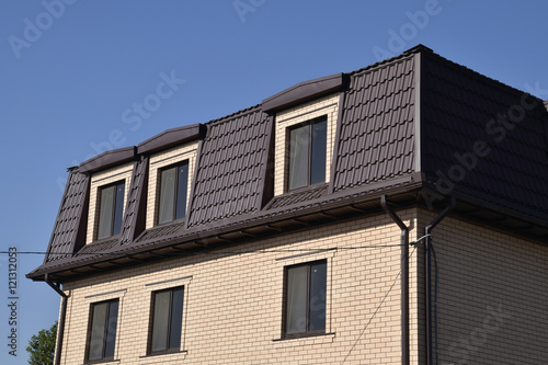 The house with plastic windows and a roof of corrugated sheet