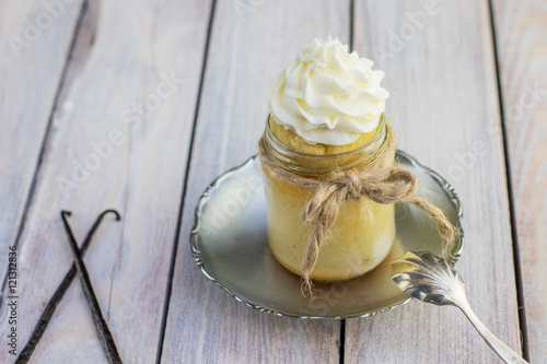 Baked pudding made from egg yolks in jar with whipped cream and
