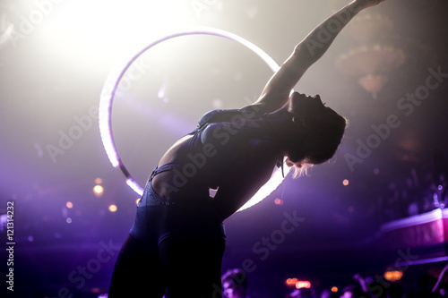 Silhouette of Hula Hooper in Nightclub Leaning Backwards