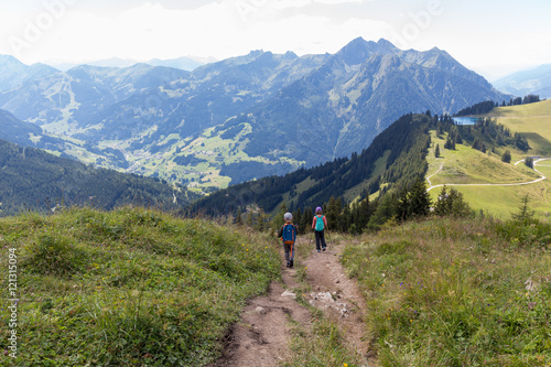 Two children are hiking in mountains