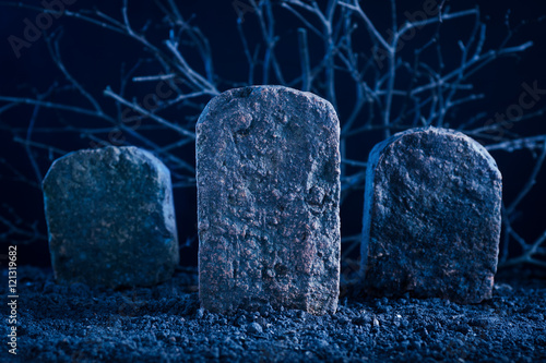 blank tombstone in the dark night at graveyard, halloween background