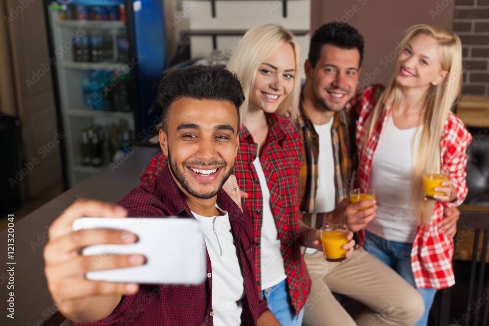 Obraz premium People Friends Taking Selfie Photo Drinking Orange Juice, Sitting At Bar Counter, Mix Race Man Hold Smart Phone