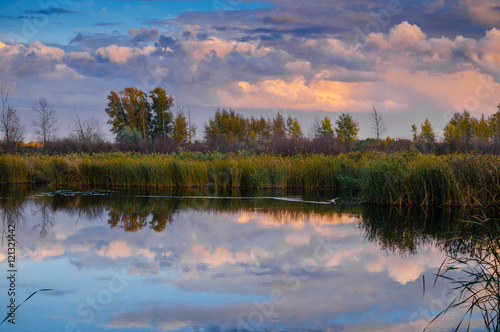 Bright clouds over a lake at sunset.