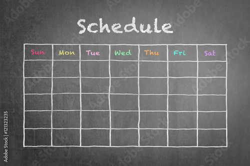 Timetable schedule on black chalkboard background photo