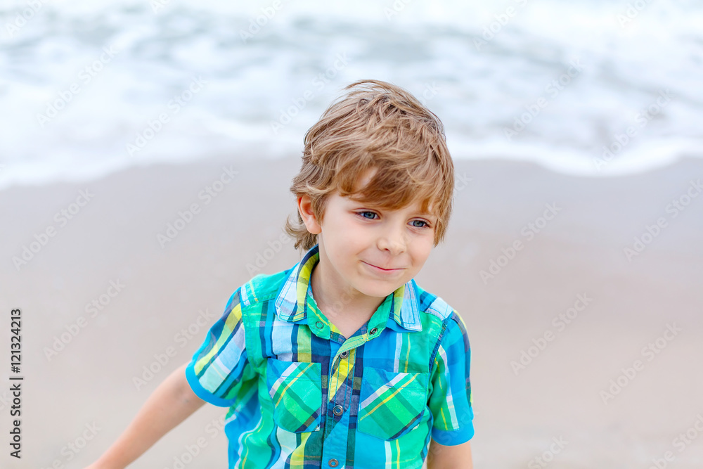 little kid boy on the beach of ocean little kid boy on the beach of ocean