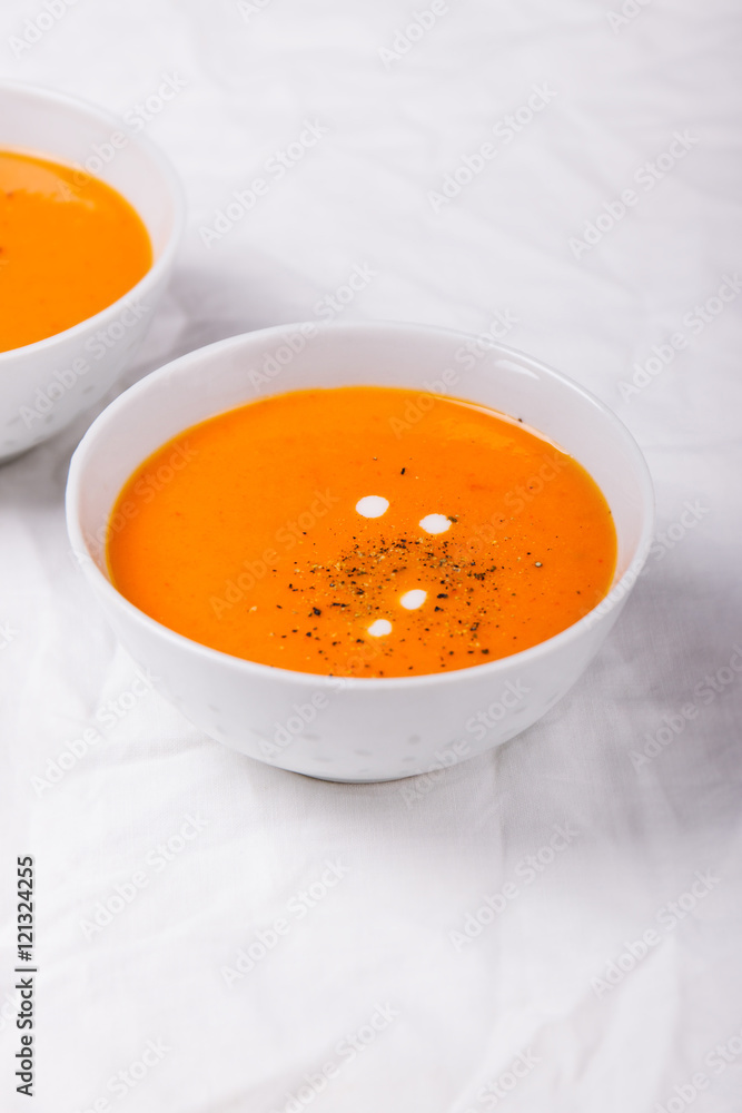 Homemade vegetable cream soup with bread on a bright background, closeup, selective focus Homemade vegetable cream soup with bread on a bright background, closeup, selective focus