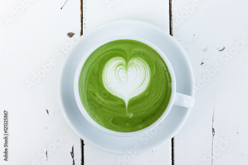 A cup of green tea matcha latte on white background