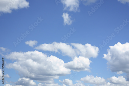 the white clouds floating on a background of blue sky