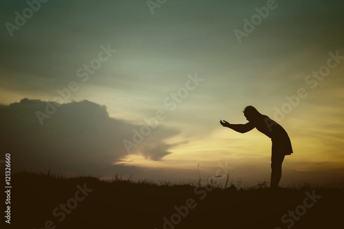 silhouette of woman Standing blessings of god at sunset