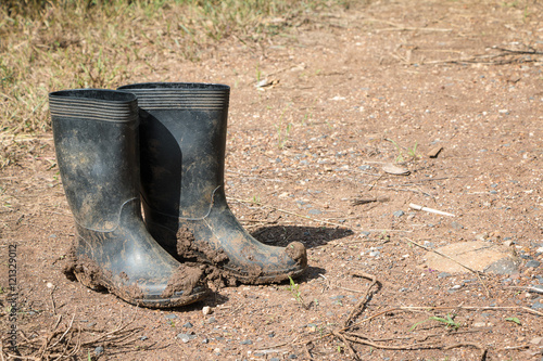 Dirty rubber boots in farm.