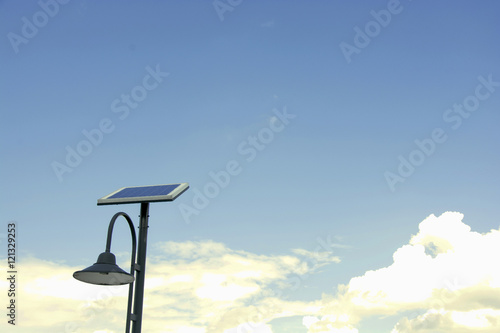 Solar panels and lamp with blue sky