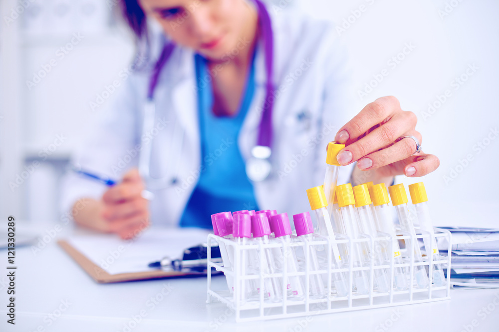 Woman researcher is surrounded by medical vials and flasks, isolated on white background Woman researcher is surrounded by medical vials and flasks, isolated on white background