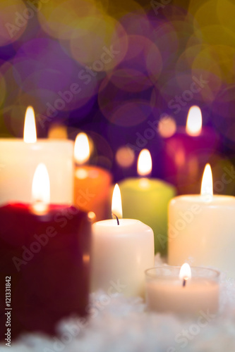 colorful candles in the snow  sparkle background