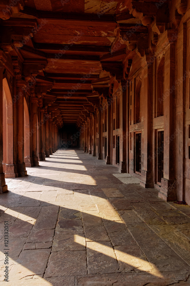 Walk down the red passage in the mosque in Fatehpur Sikri, India.