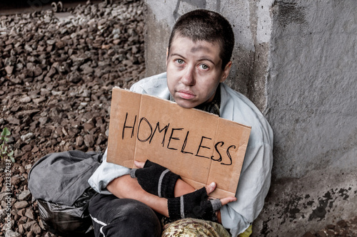 Homeless poor woman with sign photo