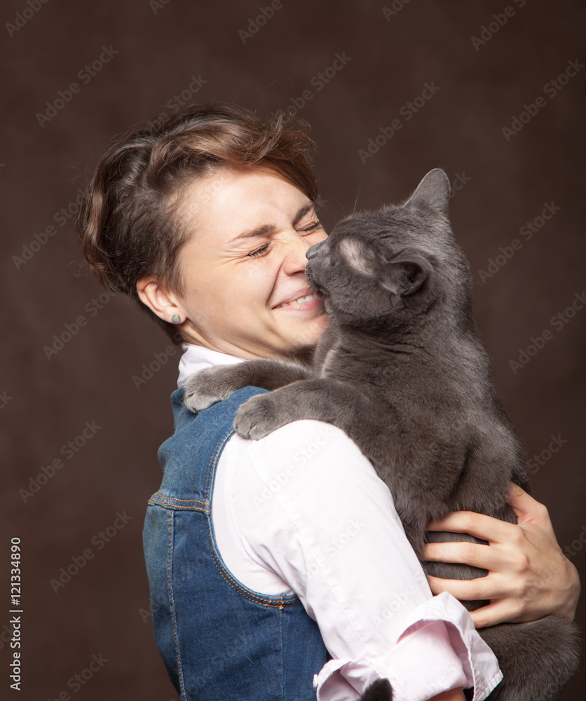Beautiful young woman with blue Russian cat. Love for pet. Studi Beautiful young woman with blue Russian cat. Love for pet. Studi