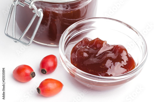 Wallpaper Mural Rose hip jam and fruits from above over white, also rose haw or rose hep. Marmelade in glass jar and bowl. Shells of red fruits can be eaten raw and are one of the richest vitamin C sources in plants. Torontodigital.ca