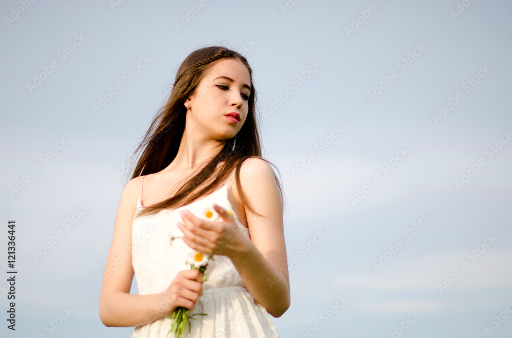 girl walking in a field with a flower girl walking in a field with a flower