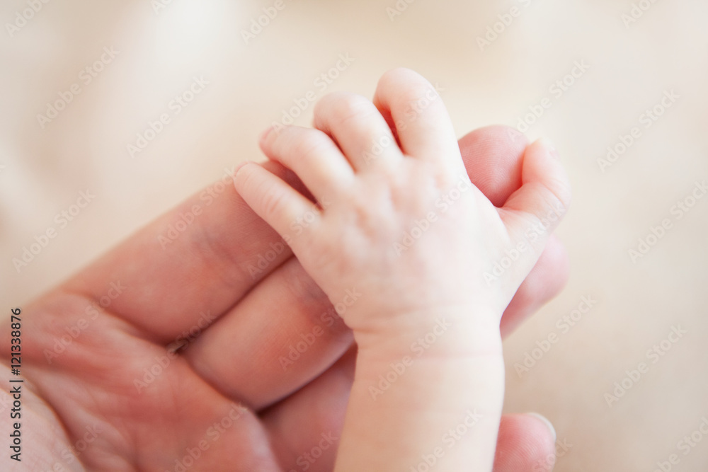 Newborn baby hand in the hand of father, close-up Newborn baby hand in the hand of father, close-up