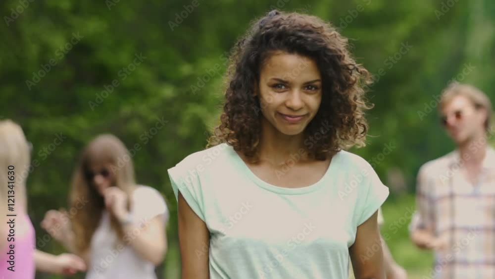 Young happy woman smiling and looking into camera, dancing at music festival Young happy woman smiling and looking into camera, dancing at music festival