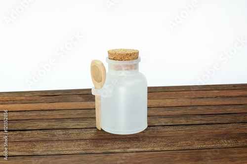 white plastic bottle with wooden spoon
