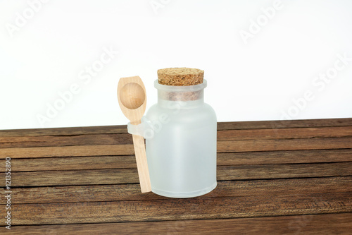 white plastic bottle with wooden spoon