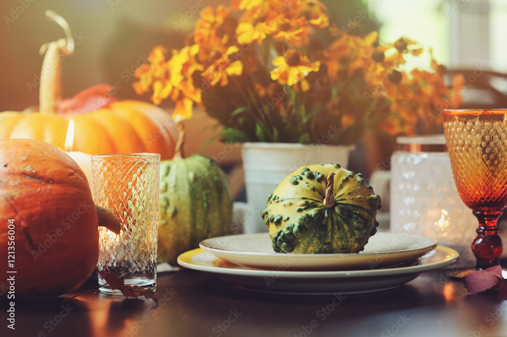 autumn traditional table setting for Thanksgiving or Halloween, with candles, flowers and pumpkins. autumn traditional table setting for Thanksgiving or Halloween, with candles, flowers and pumpkins.