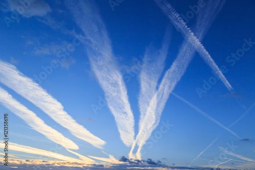 Airplane chemtrails in sky above Nottinghamshire, England.