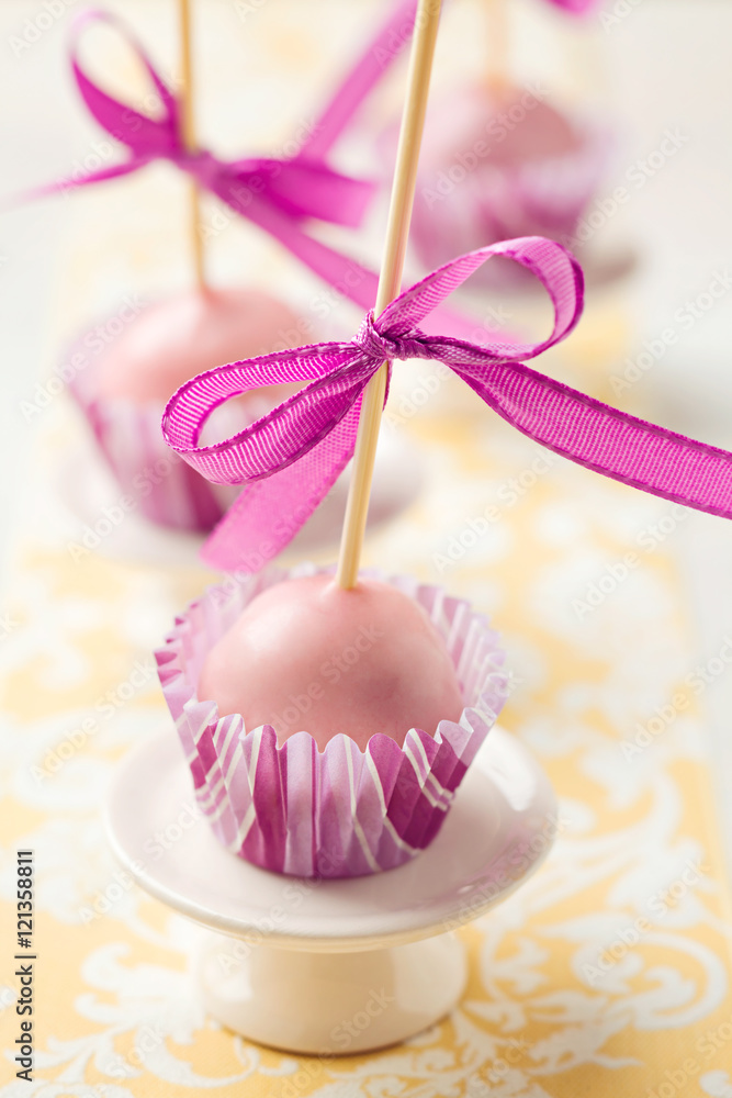 Pink Christmas cake pops sticking upside down in miniature cupcake liners.  Very shallow depth of field Stock Photo | Adobe Stock