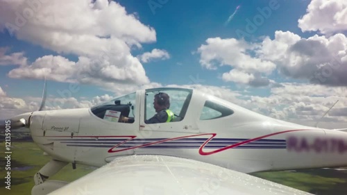 Action camera time lapse with view from wing of airplane of pilot aviating aircraft on cloudy day photo