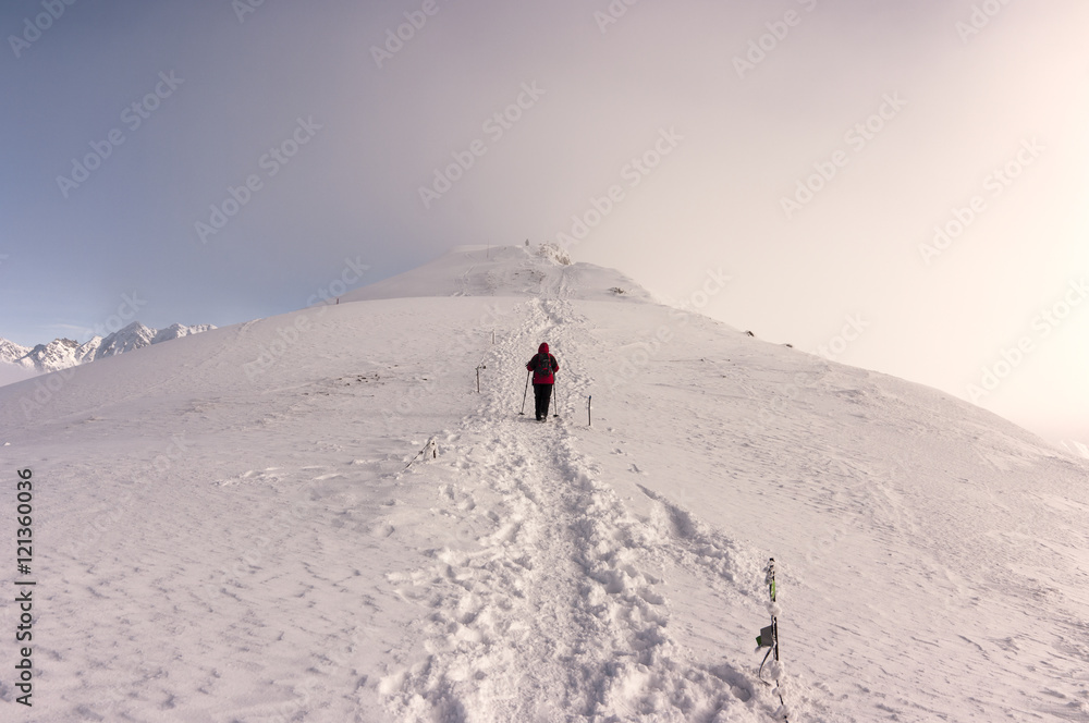 Beautiful winter mountain landscape. Single man on the ridge. Tatry