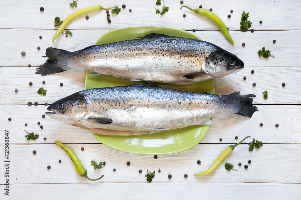 uncooked salmon, fresh fish on green plate. white background uncooked salmon, fresh fish on green plate. white background
