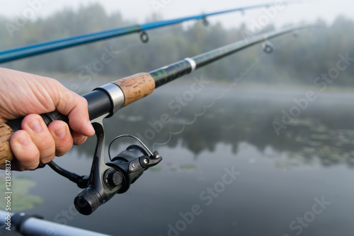 fishing rod in hand man close-up, shallow dof